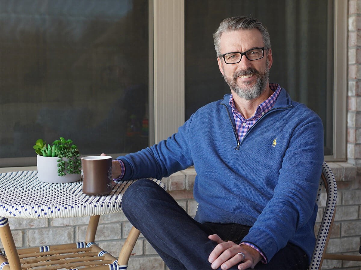 Rob Massie on his porch with a cup of coffee